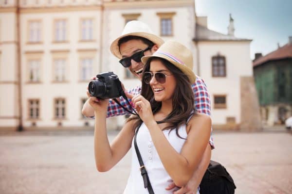 12 Best Travel Purses for women (Comfortable, Secure & Lightweight) Cute couple looking on their photos on camera