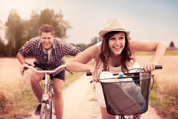 Best Summer Vacation Destinations in the US: Top Picks for 2023 Happy couple racing on bikes