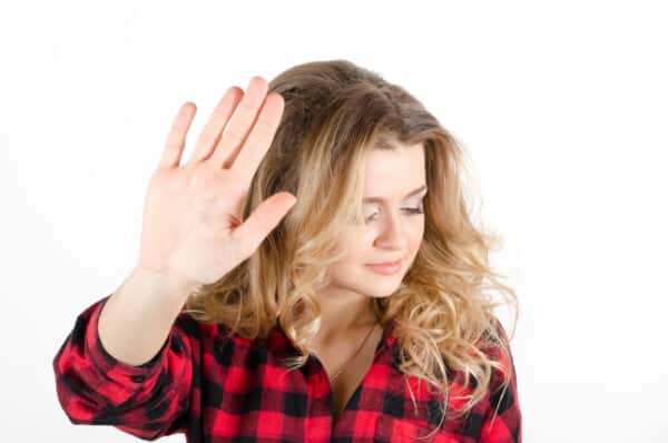Stop! 13 Costly Travel Mistakes You May Be Making young woman showing sign NO or STOP with her hand